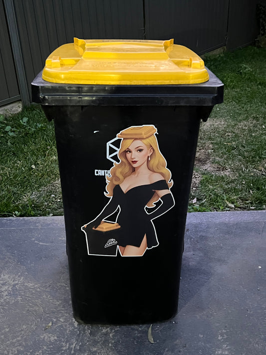 Black trash can with a yellow lid featuring a graphic design on a concrete surface.