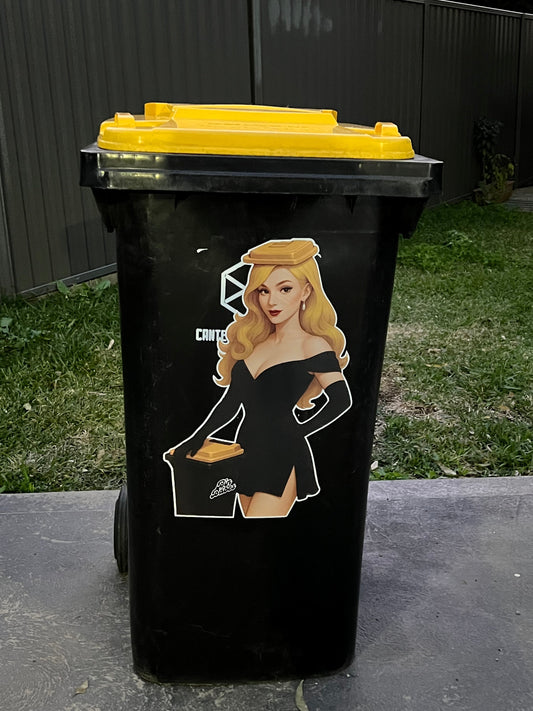 Black trash bin with a graphic design on a grassy area
